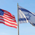 American and Israeli flags waving against a clear sky