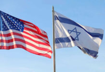 American and Israeli flags waving against a clear sky