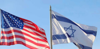 American and Israeli flags waving against a clear sky