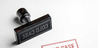 Rubber stamp with the words COLD CASE next to a stamped impression