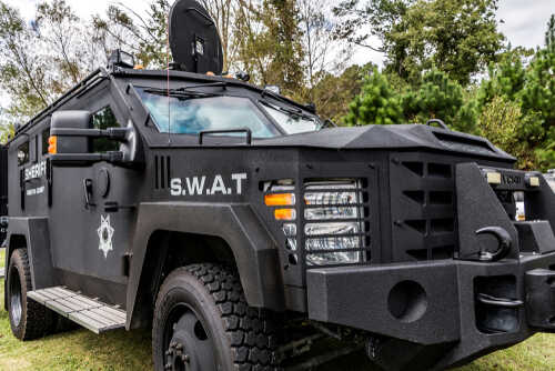 Armored SWAT vehicle parked in a grassy area