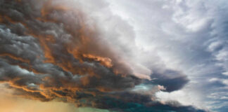 Dramatic storm clouds over a flat landscape.