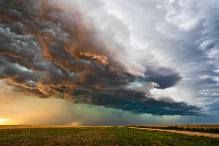 shutterstock_1694358319.jpg Dramatic storm clouds over a flat landscape.