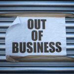 Union Outcry Over Retailer’s Surprising Closure Plan Out of Business sign on closed store shutters
