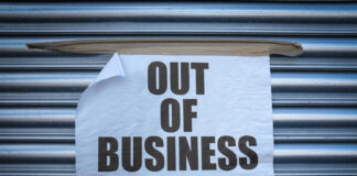 Out of Business sign on closed store shutters