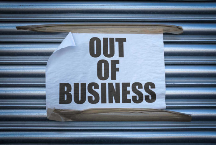Out of Business sign on closed store shutters