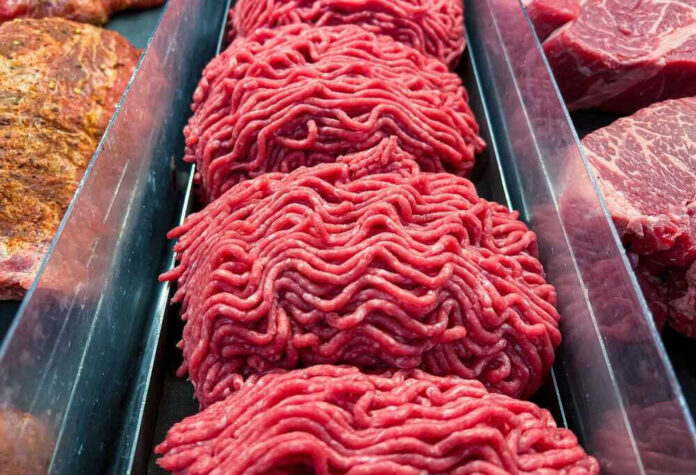 shutterstock_2235417437.jpg Ground beef on display at a butcher shop.