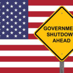 Shutdown Chaos: Social Security Turmoil Looms American flag government shutdown warning sign