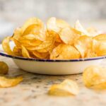 A bowl filled with golden, crispy potato chips