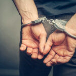 Person with handcuffs behind their back