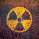 Faded radiation symbol on a rusty surface