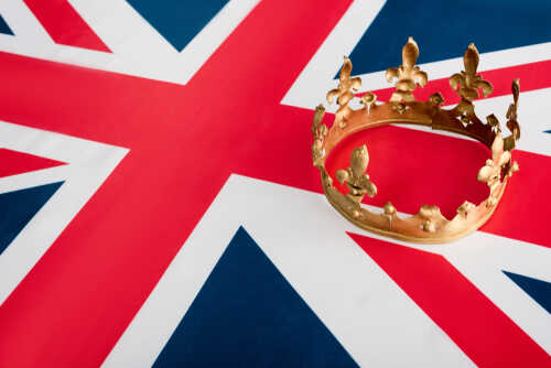A golden crown resting on the Union Jack flag