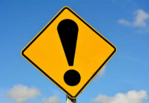 HORRIFYING Government Raid Kills 98-Year-Old Woman Yellow caution sign with exclamation mark symbol.