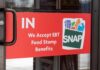 Sign on a store door indicating acceptance of EBT food stamp benefits