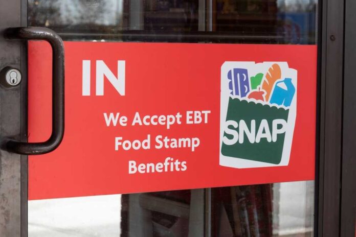 Sign on a store door indicating acceptance of EBT food stamp benefits