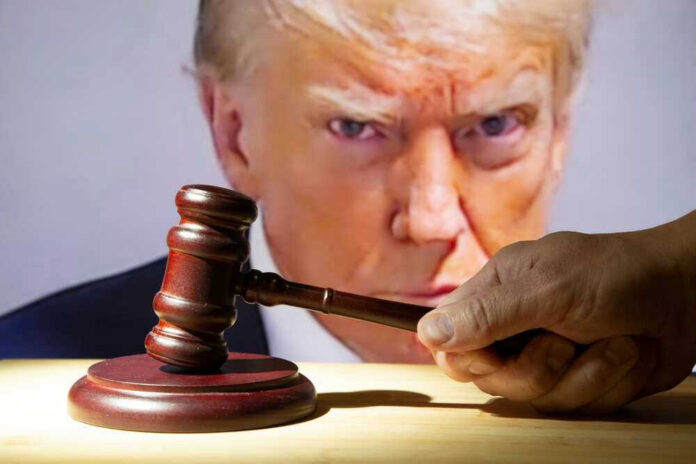 shutterstock_2362003039.jpg Gavel in front of Donald Trumps face on screen.