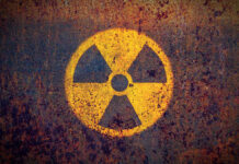 Faded radiation symbol on a rusty surface