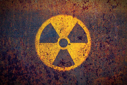 Faded radiation symbol on a rusty surface