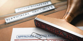 Declassified stamp on government document with paperclip