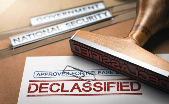 Declassified stamp on government document with paperclip