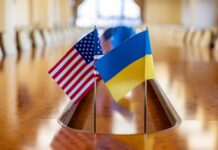 Flags of the United States and Ukraine on a conference table