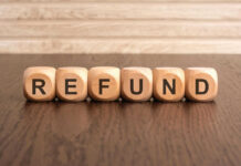 Wooden blocks spelling refund on table