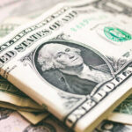 U.S. dollar bills with George Washington visible.