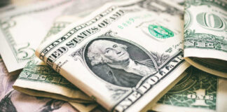 U.S. dollar bills with George Washington visible.