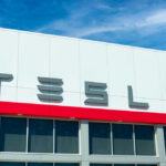 Tesla building with logo against blue sky