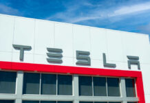 Tesla building with logo against blue sky