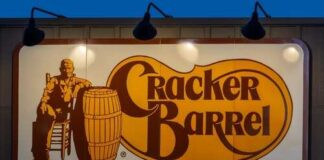 Cracker Barrel restaurant sign featuring a seated figure and a barrel