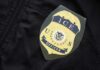 Homan’s Bold Move Shifts ICE Focus Close-up of an ICE officer badge on a black jacket