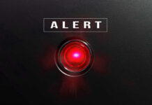 TRUMP Unleashes Deadly Retaliation Strike Red alert light against black background, text ALERT.