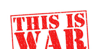 A bold red stamp with the text 'THIS IS WAR'
