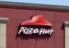 Pizza Hut sign on a red wall