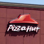 Pizza Hut sign on a red wall