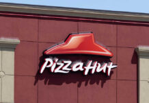 Pizza Hut sign on a red wall