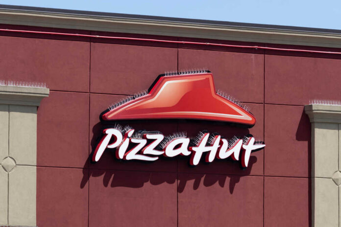 Pizza Hut sign on a red wall