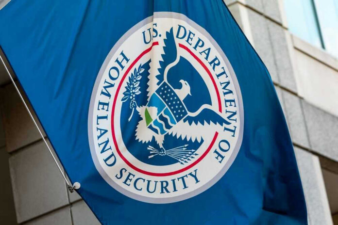 shutterstock_20573627091.jpg U.S. Department of Homeland Security flag on building.