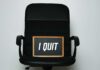 An office chair with a framed sign that says 'I QUIT'