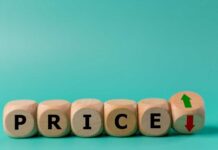 Wooden blocks spelling 'PRICE' with arrows indicating increase and decrease