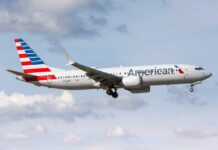 ATTACK Rocks American Airlines Colombia Flight American Airlines airplane approaching for landing against a cloudy sky