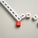 A red warning block surrounded by white blocks with directional arrows