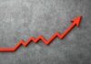 Red arrow graph indicating upward trend on a textured background