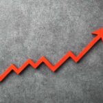Red arrow graph indicating upward trend on a textured background