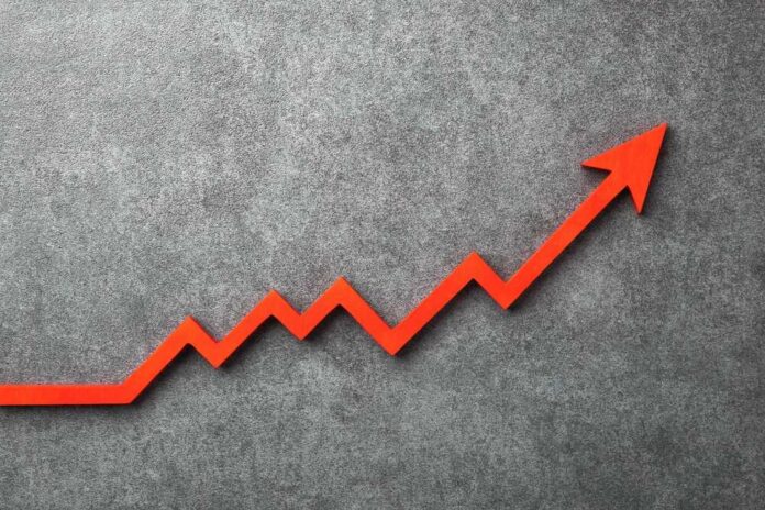 shutterstock_2652850717.jpg Red arrow graph indicating upward trend on a textured background