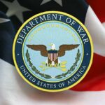 Emblem of the Department of War on a background of the American flag