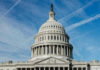 Congress FROZEN — Trump Acts on Standoff U.S. Capitol building dome against blue sky.