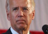 Biden’s Protector Shoots Himself at Airport Man speaking in front of a microphone.