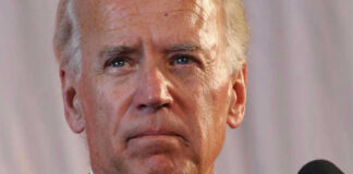 Man speaking in front of a microphone.